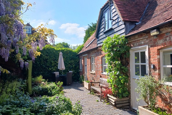 Front view of the cottage with the walled garden
