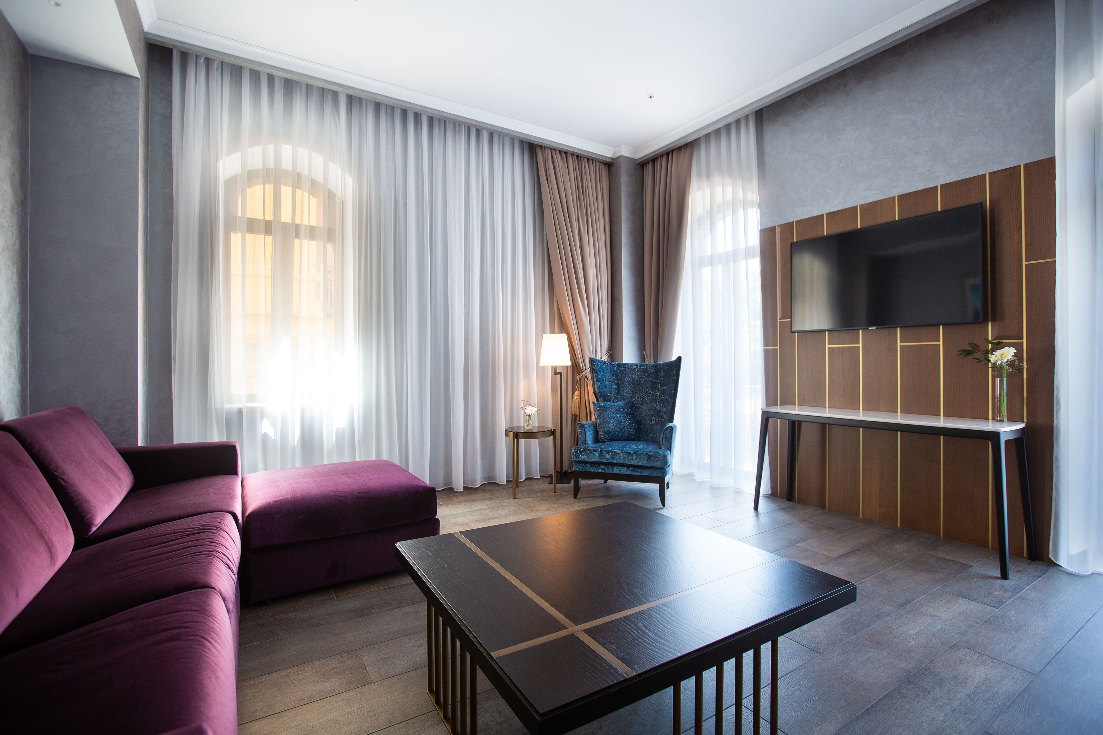 deluxe suite, 2 bedrooms, shared bathroom, partial sea view | living room | flat-screen tv, heated floors