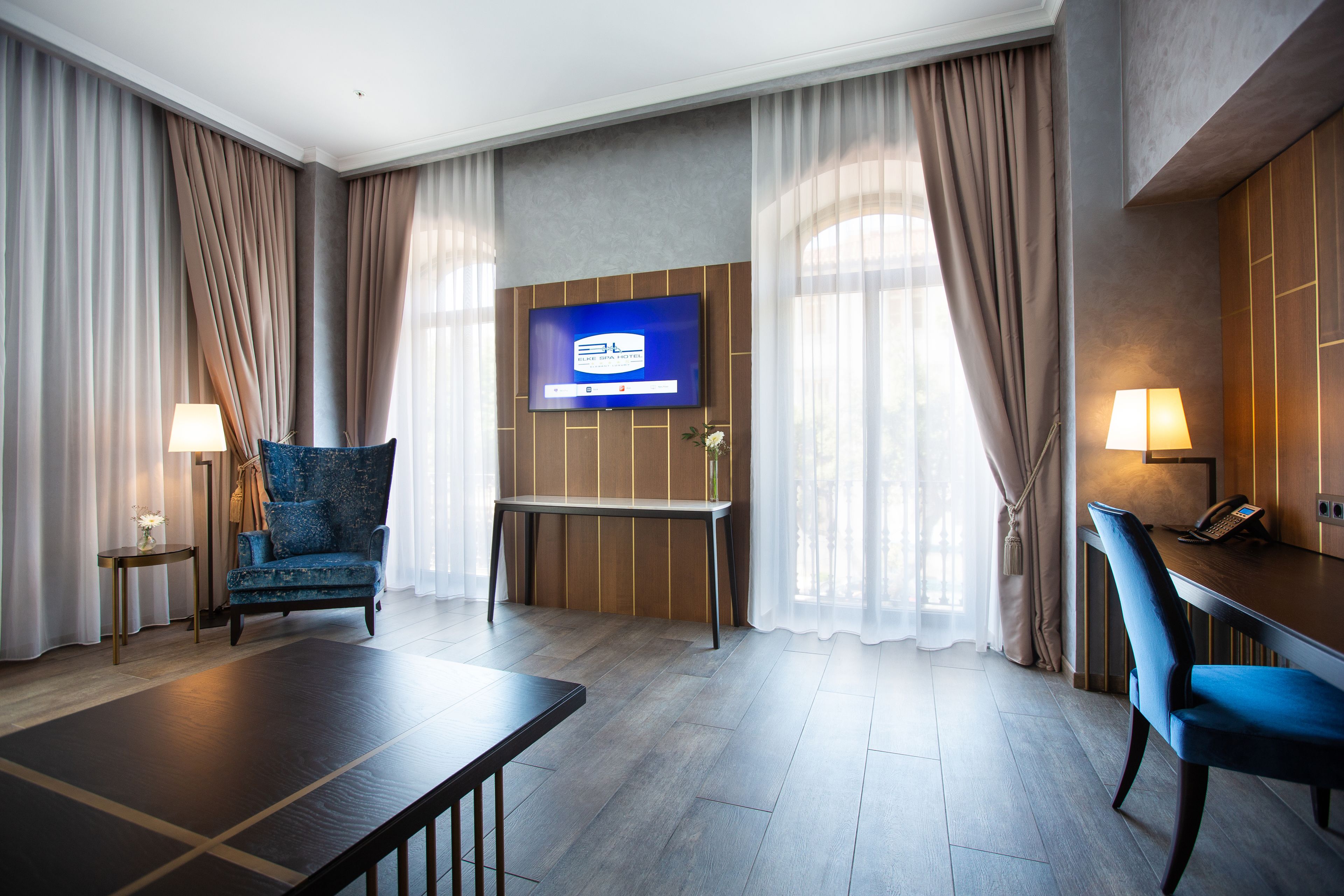 deluxe suite, 2 bedrooms, shared bathroom, partial sea view | living room | flat-screen tv, heated floors