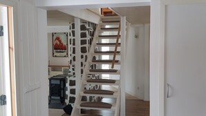 A staircase with a unique stone wall design leading to a second floor. - Fantastic nature, hot tub, boat, sauna (Olofström / Gränum)
