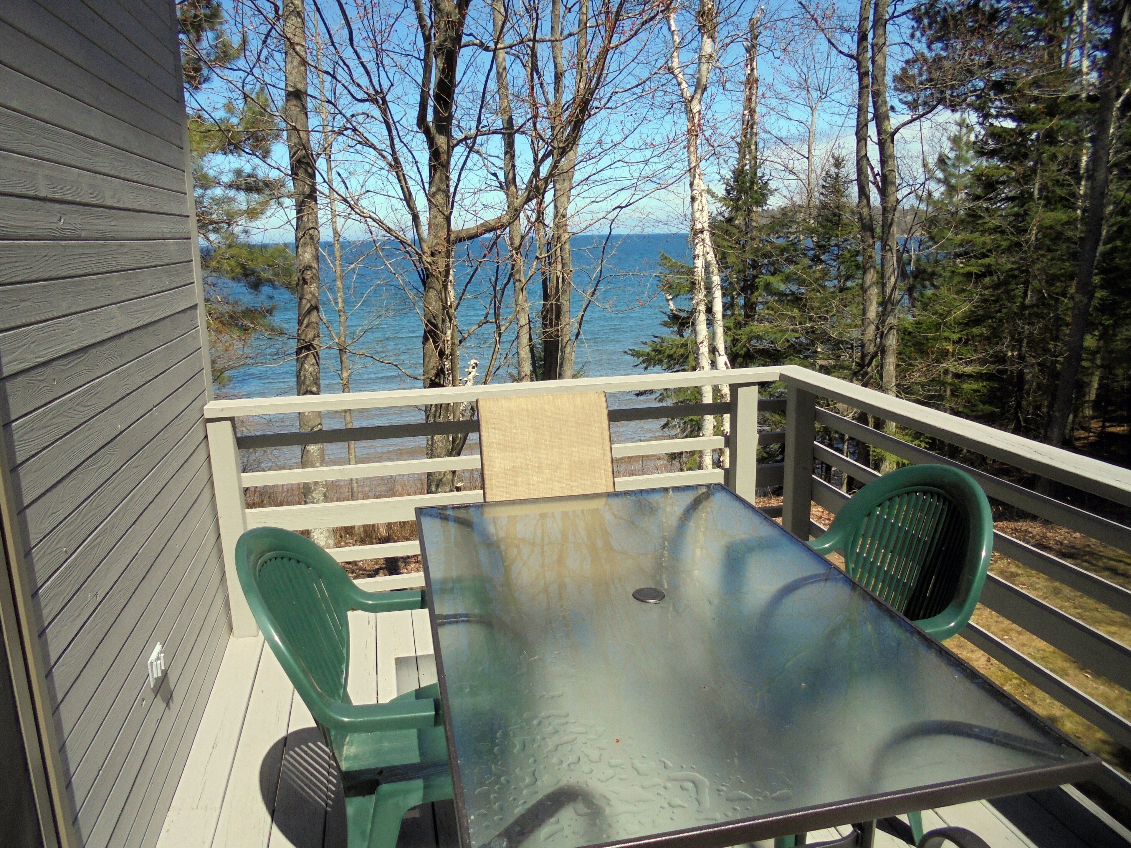 Deck with table, chairs, and grill. 