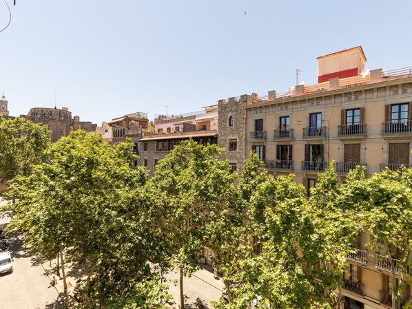A multi-story building with balconies and a mix of architectural styles, including a stone tower. - Studio 2 pax in Born (Barcelona)