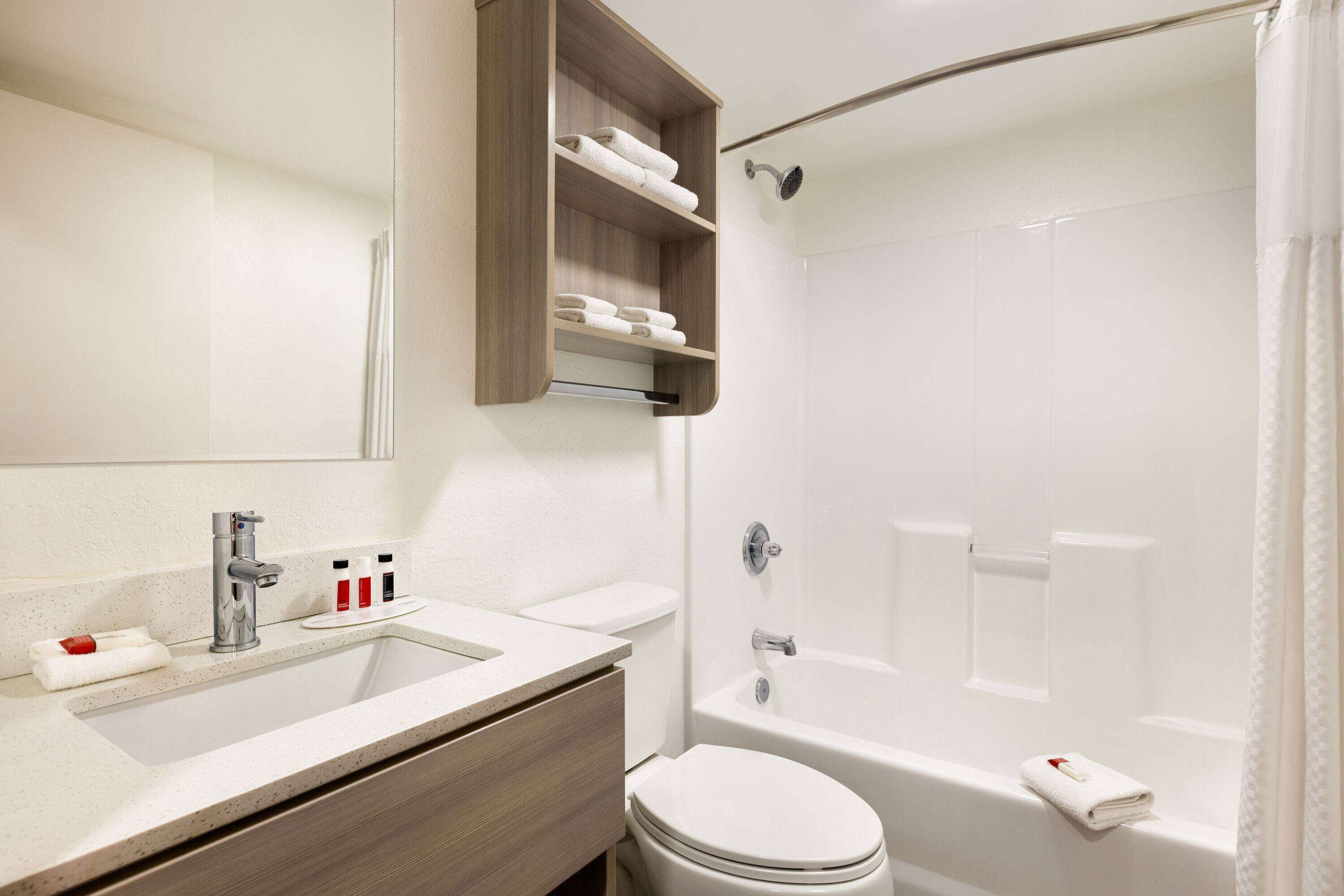 Un baño moderno con lavamanos, inodoro y bañera.