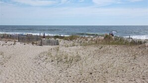 A beach with a wooden fence, sandy dunes, and the ocean. - Beautiful 5-bedroom 5-bathroom home on the Beach at the Jersey Shore (Point Pleasant Beach)