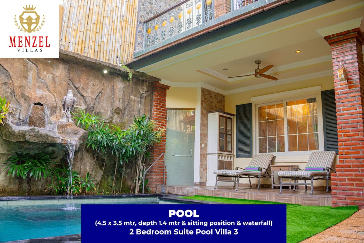 A 2-bedroom suite with a pool measuring 4.5 x 3.5 meters, a waterfall, and a patio with seating.