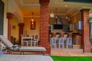 A 2-bedroom suite with a pool, sun loungers on the terrace, and a kitchen area.