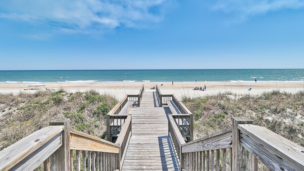 A wooden boardwalk leading to a beach with clear skies. - Litchfield Beach 3Bed/3Bath w Sleeper sofa Oceanfront Condo in Pawleys Island SC (Pawleys Island)