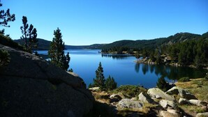 A serene lake surrounded by mountains and trees.