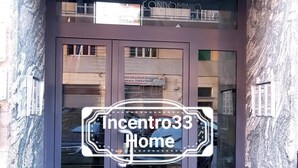 A building entrance with a dark facade and glass doors. - B&B In Centro 33 Home (Salerno)