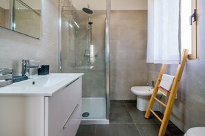Regadera, secadora de cabello, bidet, toallas