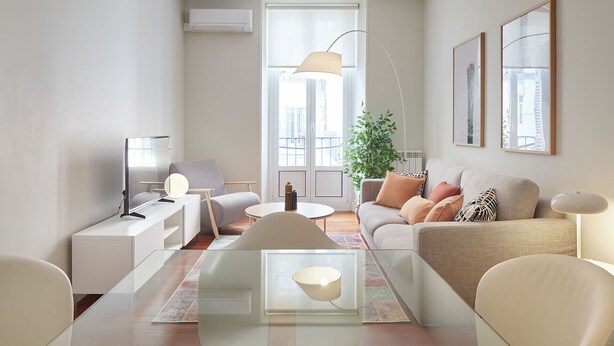 A modern living room with a glass coffee table, a sofa with cushions, a chair, a floor lamp, and a side table with a lamp. - Hondarribia | The Rentals Collection (San Sebastián/Donostia)