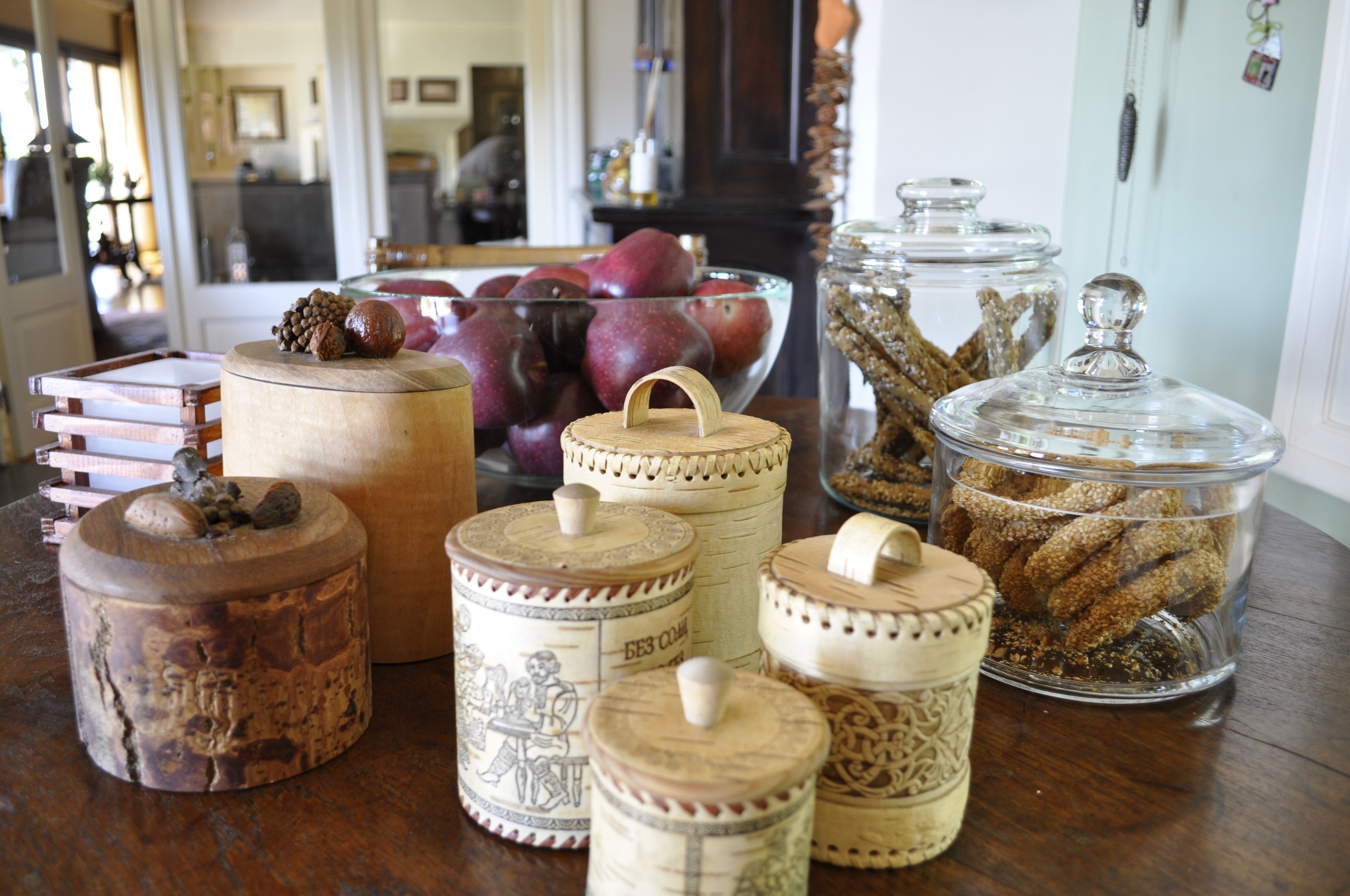 A variety of storage containers with lids on a wooden table.