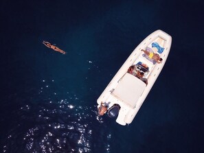 A boat with a covered deck and a motor at the stern.
