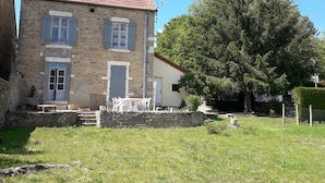 A stone house with a tiled roof, a small front garden, and a large tree to the right. - IN THE PEACEFUL HEART OF THE VINEYARD (Nolay)