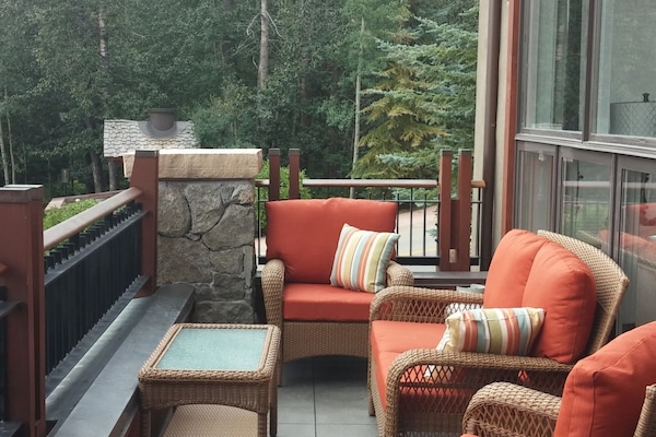 front deck with sitting area and spectacular mountain/slope views and creek