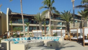 A poolside area with lounge chairs and a circular seating arrangement.