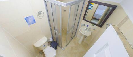 A compact bathroom with a toilet, bidet, and sink.