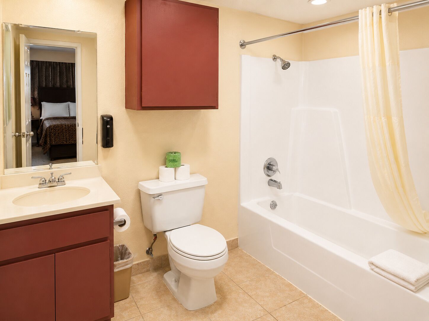 A bathroom with a toilet, sink, and bathtub.