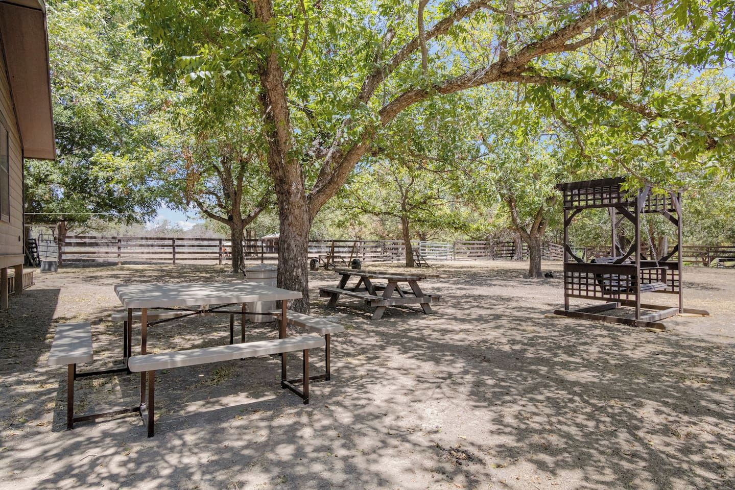 An outdoor area with picnic tables and a gazebo.