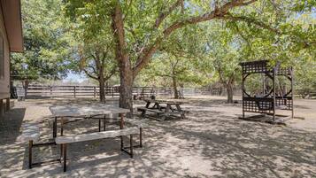 An outdoor area with picnic tables and a gazebo.