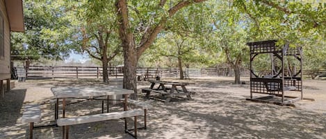 An outdoor area with picnic tables and a gazebo.