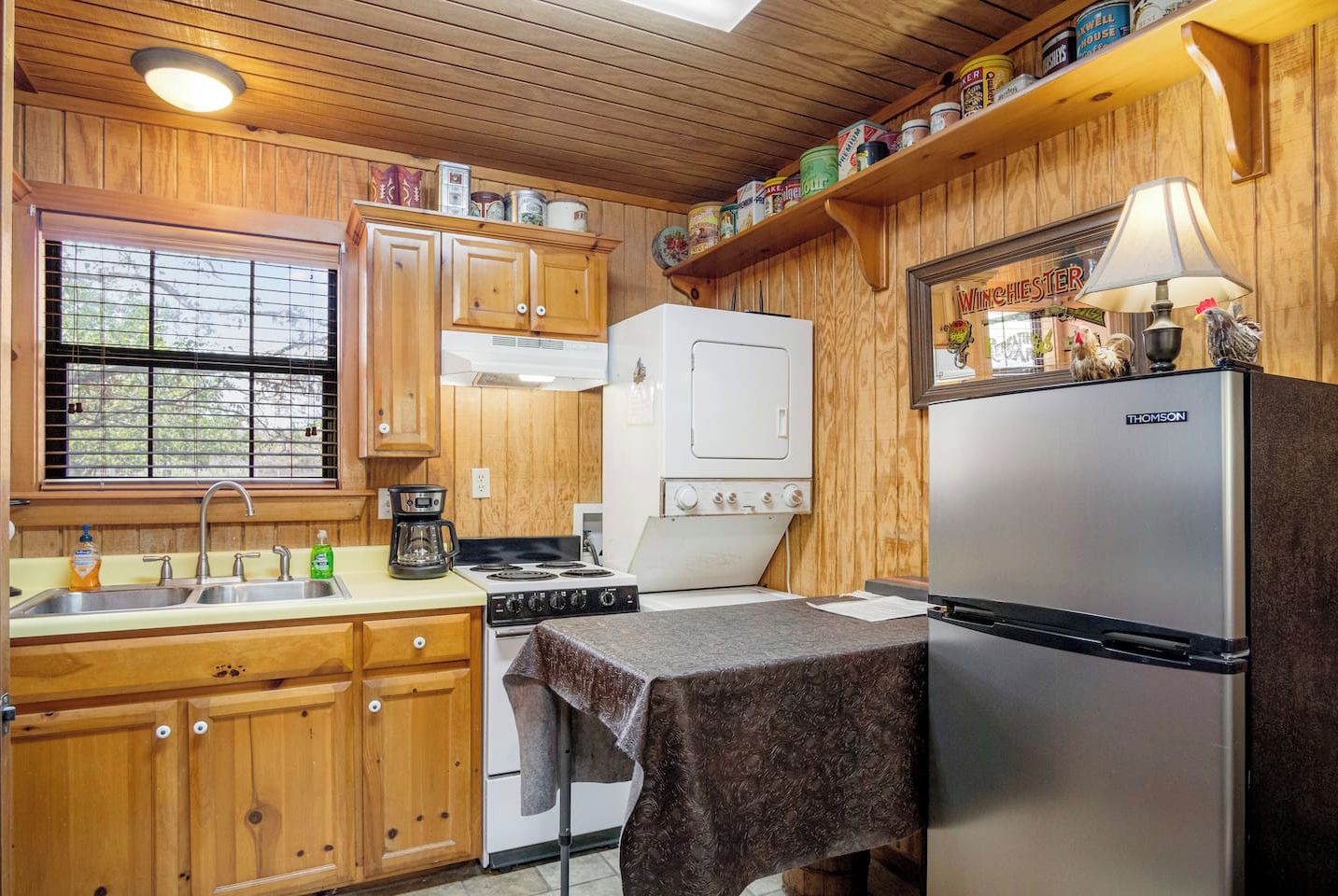 The fully-appointed kitchen is loaded with appliances, including a convenient stackable washer and dryer in the corner.