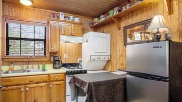 The fully-appointed kitchen is loaded with appliances, including a convenient stackable washer and dryer in the corner.