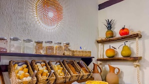 A buffet with various food items and baskets.