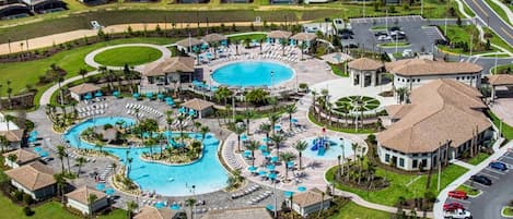 A resort with multiple swimming pools, a central courtyard, and a parking area.