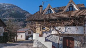 Ein Haus mit einer Steinstufe, einer Holztür und einem Auto auf der Einfahrt.