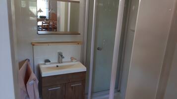 Shower, hair dryer, soap, toilet paper