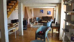 A spacious living room with a staircase, a sofa set, and a television. - House / Villa - AUPS (Aups)