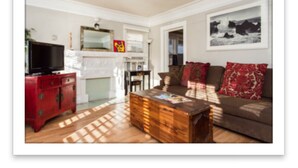 A living room with a red cabinet, a wooden coffee table, and a brown sofa with red cushions. - Classic & Central Hollywood Retreat with Porch and Garden (Los Angeles)
