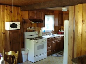 Enjoy cooking in this well-equipped kitchen with a gas stove, microwave, and refrigerator.