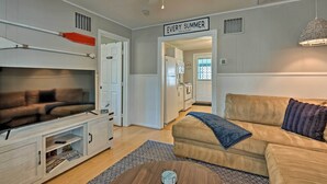 A living room with a TV, sofa, and a sign that reads "EVERY SUMMER". - 'The Blue Crab Cottage' - 3 Blocks From The Beach! (Colonial Beach)