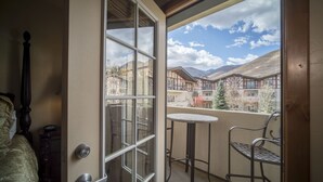 A room with a large window, a door, a small table, and a chair. - 3 Bedroom~Heated Pool, Tubing & Ice Skating Villa 2082-3 (Midway)