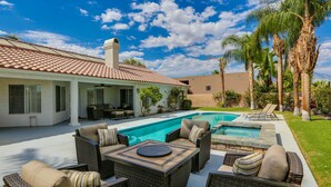 A backyard with a swimming pool, outdoor furniture, and palm trees. - Palm Desert Oasis For The Whole Family To Enjoy (Palm Desert)