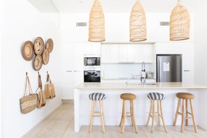 Enjoy cooking in this well-equipped kitchen with a central island and stainless steel appliances.
