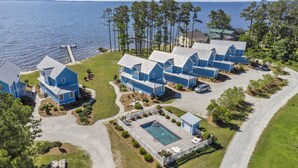 A cluster of blue cabins with a swimming pool and dock by the water. - Neuse Village #7 - Experience your inner peace! (Arapahoe)