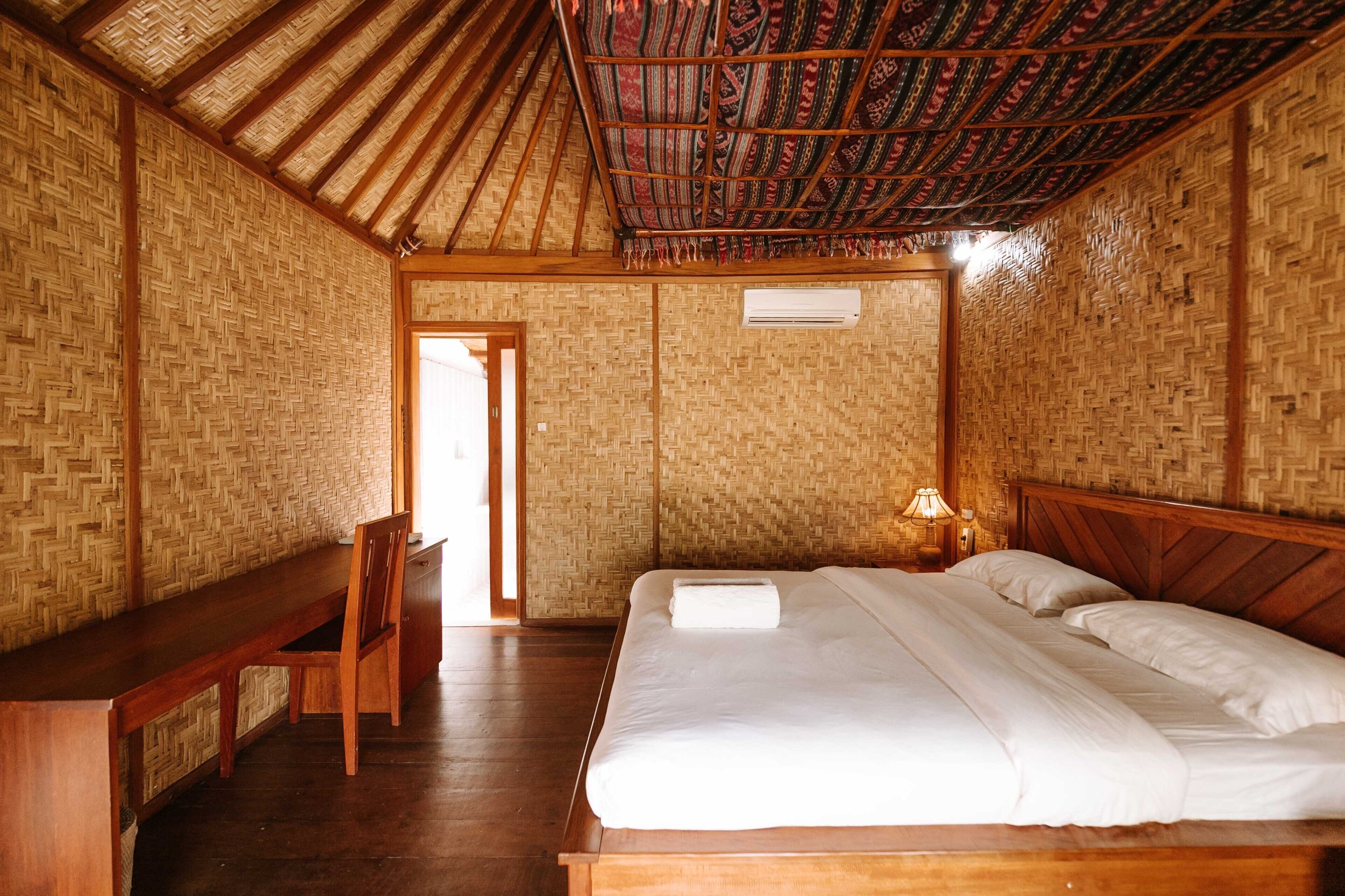 A room with a bed, a desk, and a chair.