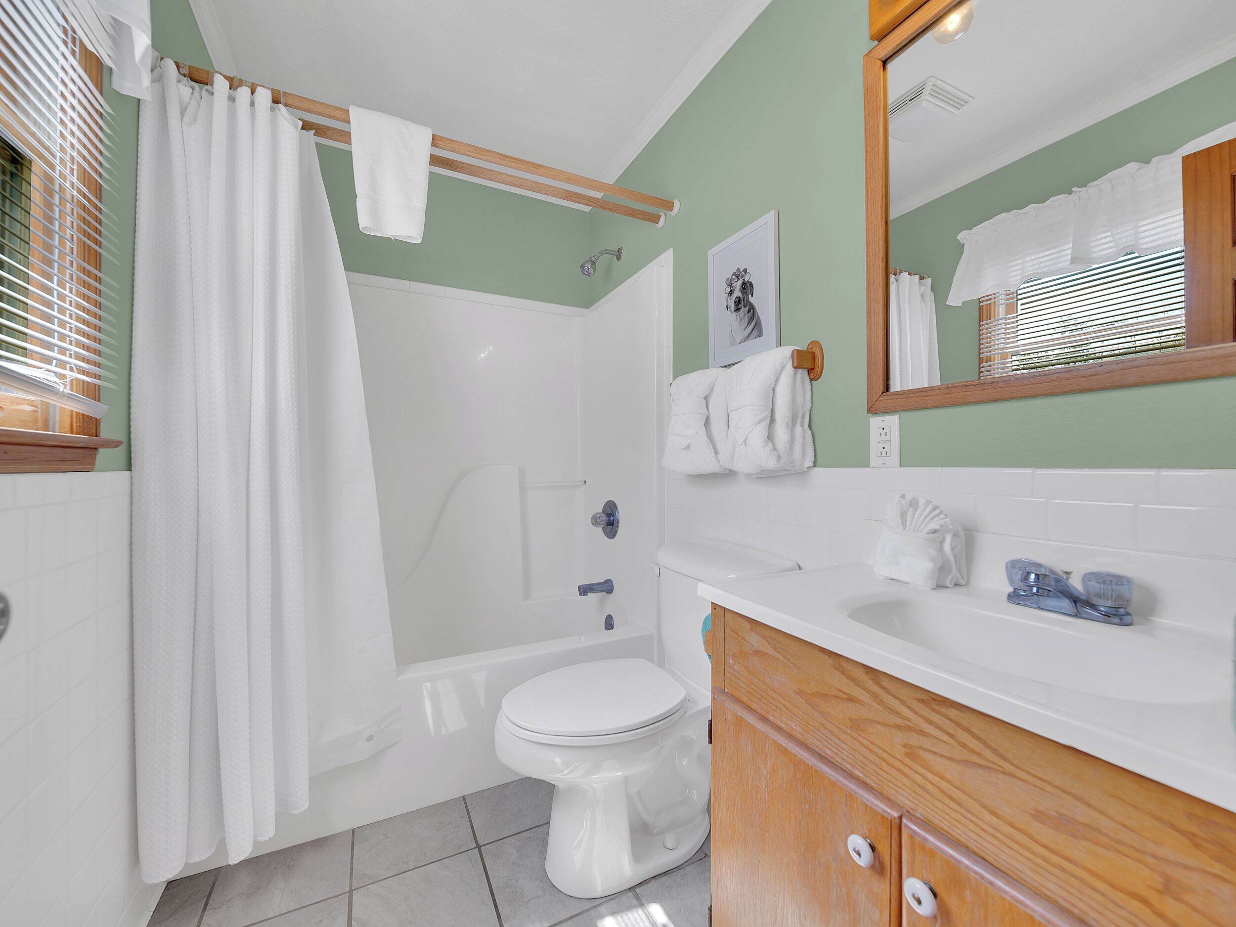 A bathroom with a bathtub, toilet, and sink.