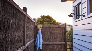 A wooden fence with a blue cloth and a hat hanging on it. - Grace—Stunning Oceanview Escape on Cowaramup Bay (Gracetown)