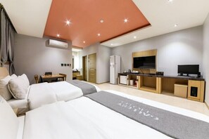 A modern hotel room with a large bed, a desk, a TV, and an air conditioning unit. - Gallery Hotel (Gwangju)