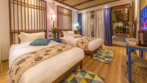 A hotel room with two beds, a wooden ceiling, a small table, and a view of a staircase leading to a balcony. - Floral Hotel Lijiang Exclusive Memory (Lijiang)