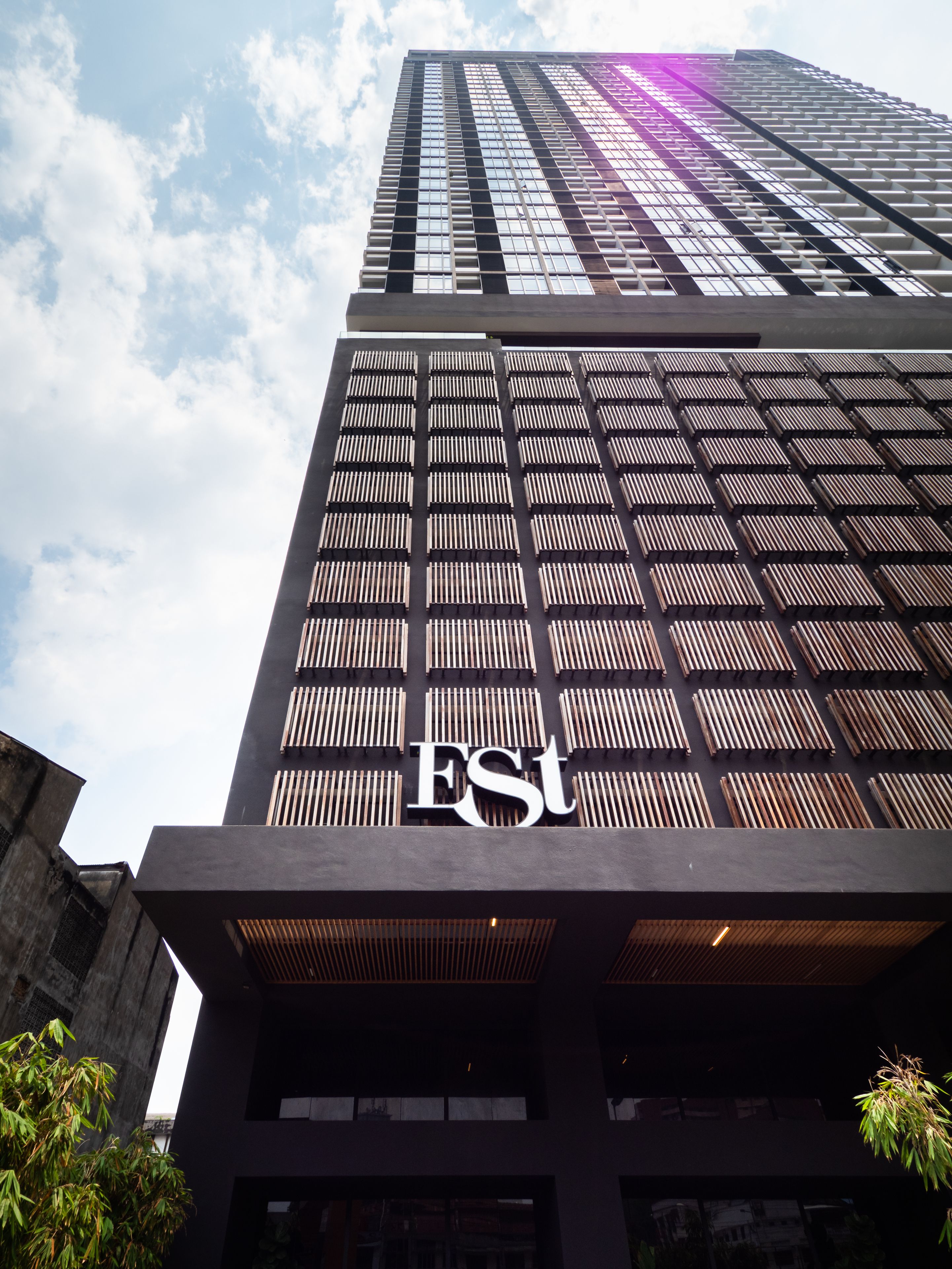 Un grand immeuble dont la façade est ornée d’un panneau bien visible indiquant « EST ».
