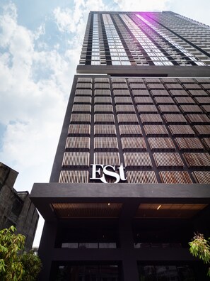 A tall building with a prominent 'EST' sign on the facade. - The Establishment at Bangsar KL Sentral (Kuala Lumpur)