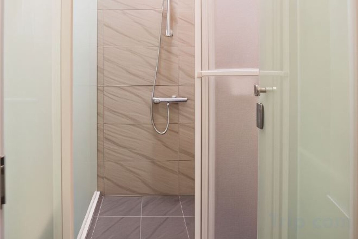 Bathroom | Shower, hair dryer, slippers, towels