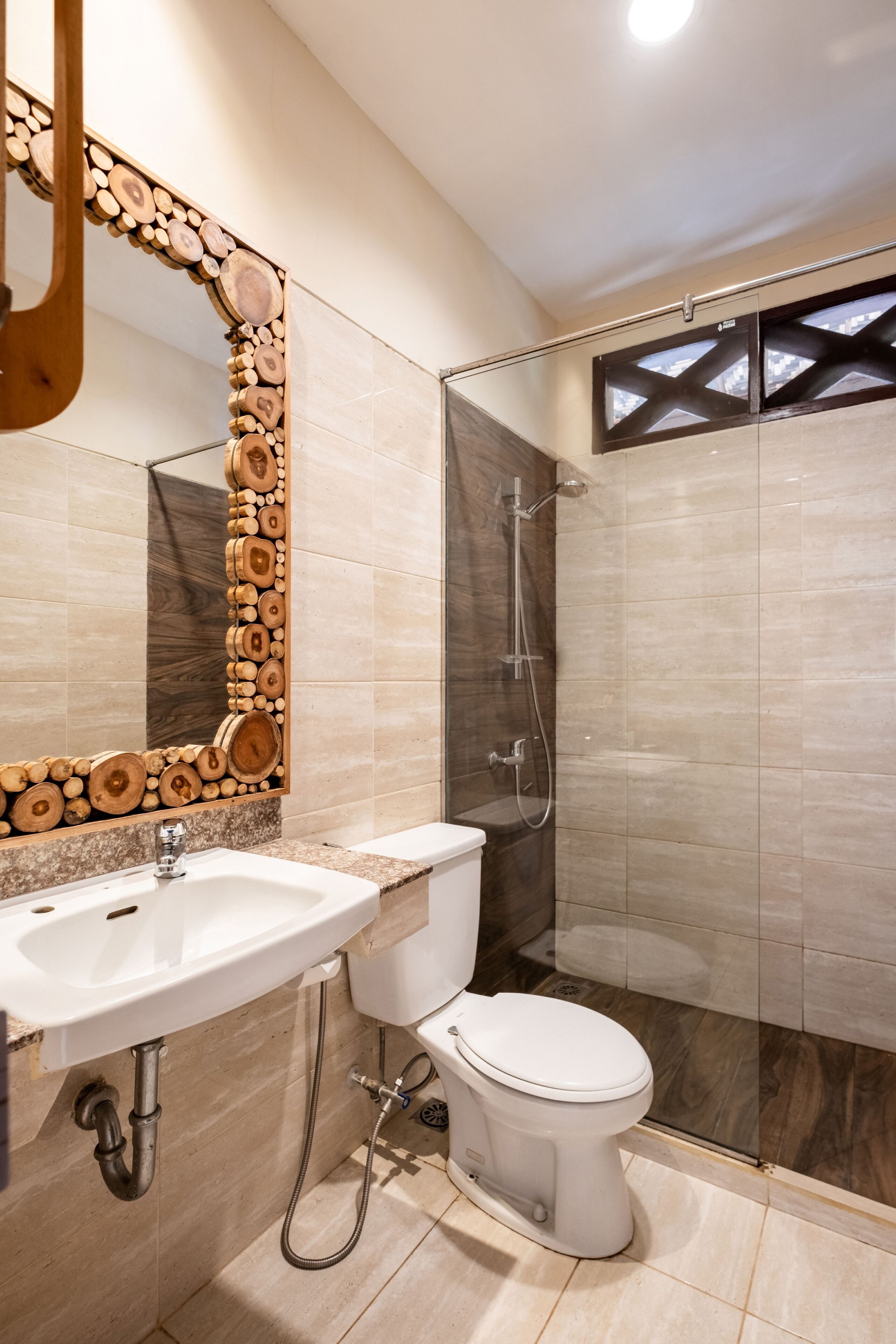 A modern bathroom with a sink, toilet, and glass-enclosed shower.
