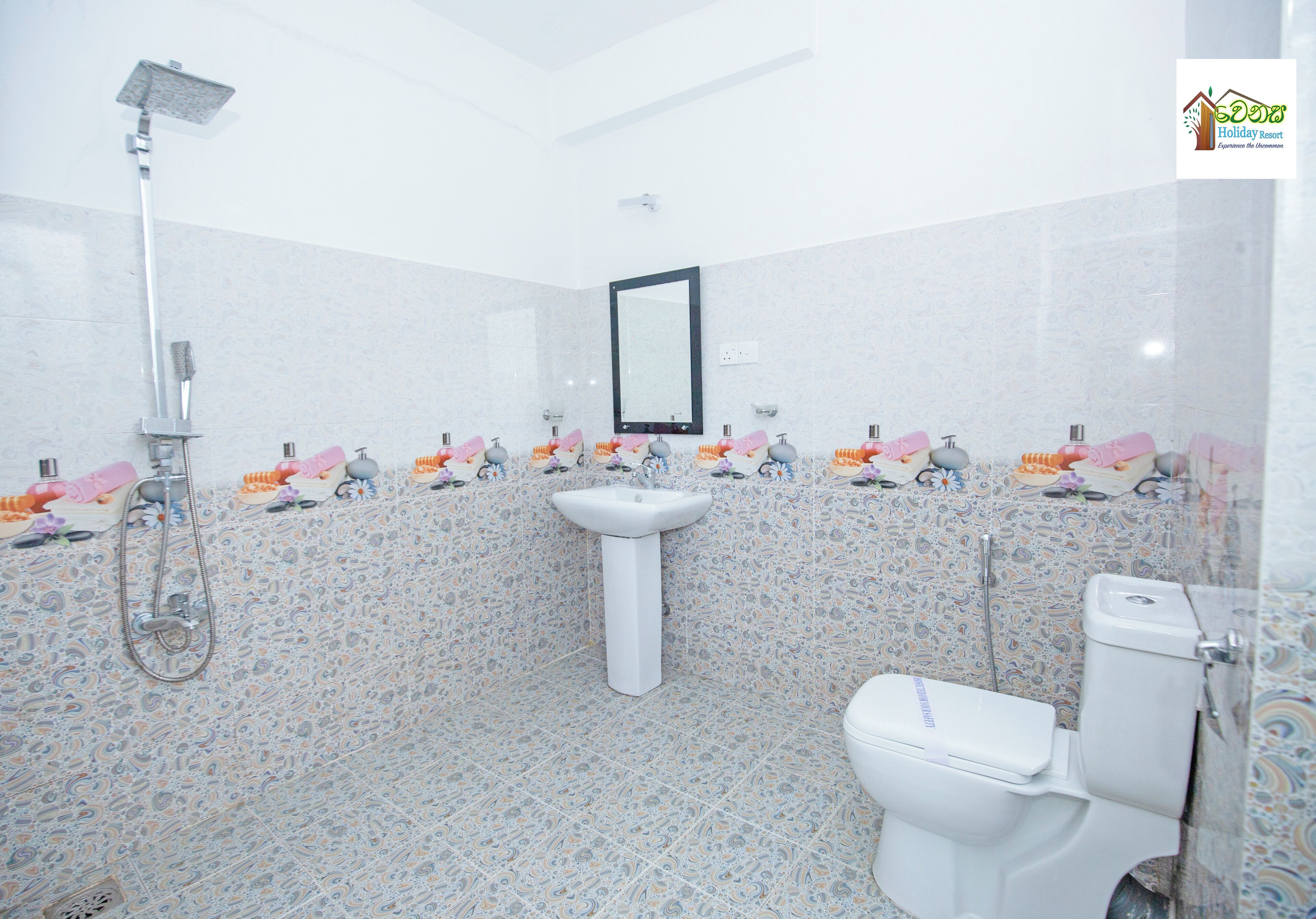 A bathroom with a shower, sink, and toilet.