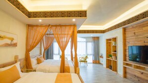 A hotel room with a large bed, a TV, a wooden bookshelf, and a balcony with a view. - Floral Hotel Fenghuang Huercaowu (Xiangxi)
